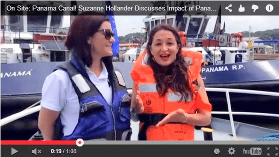 Two women in life jackets talking to each other.